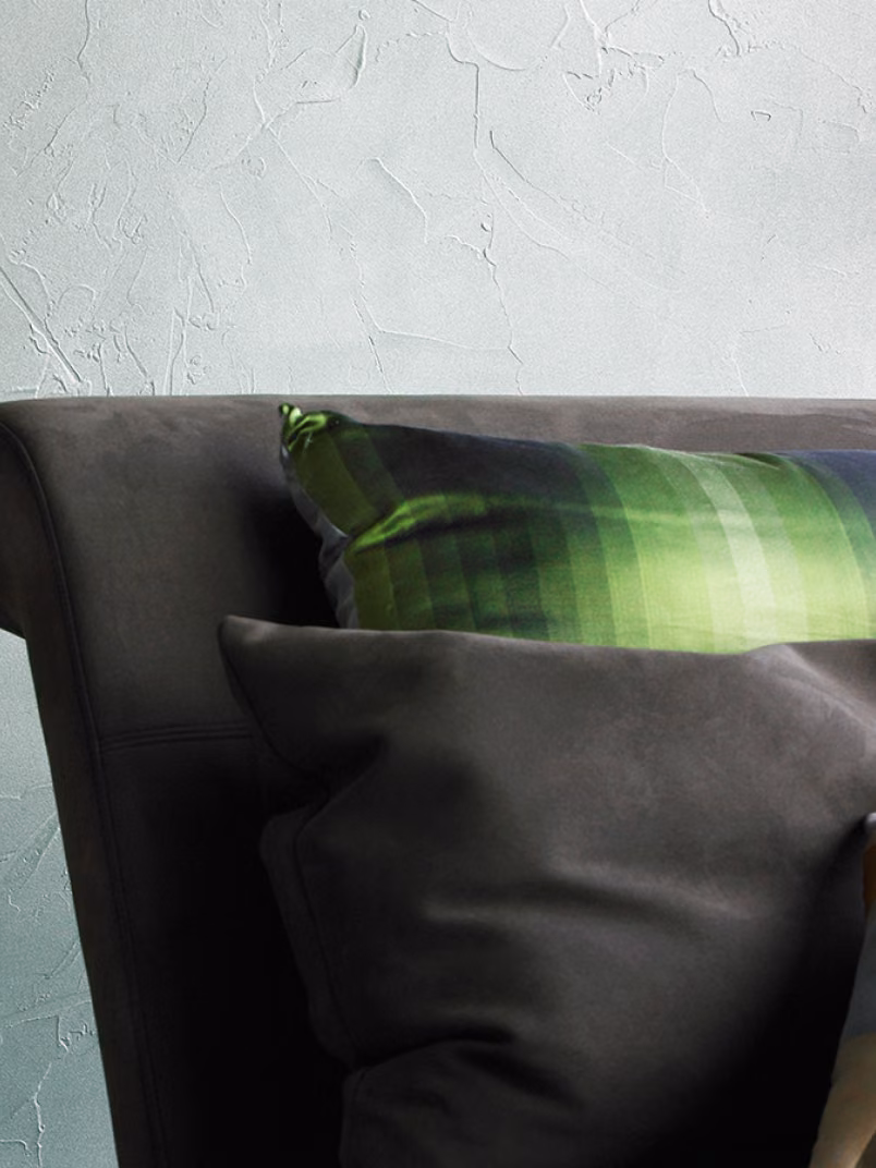 The textured surface, reminiscent of plaster, is finished with a pearlescent sheen. 