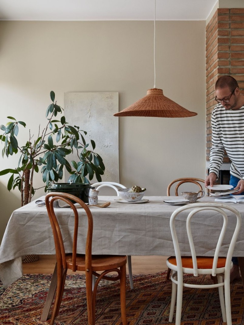 bohemian dinning room with beige colour wall and green plants