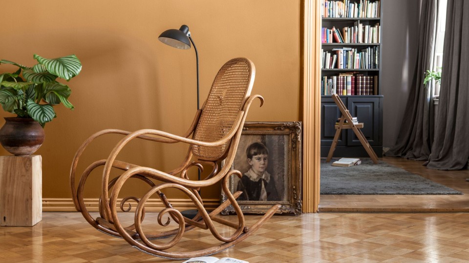 earthy yellow wall colour in living space with rocking chair