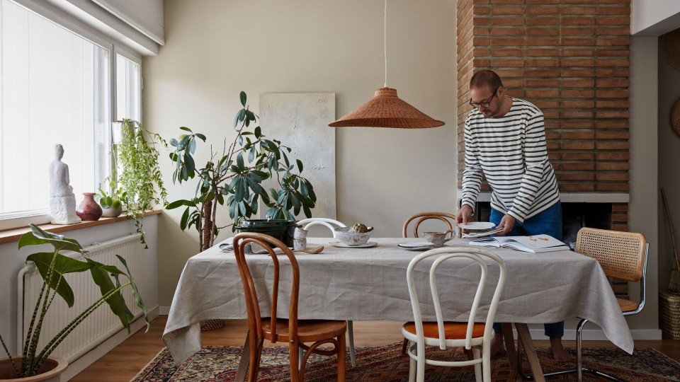 bohemian dinning room with beige colour wall and green plants