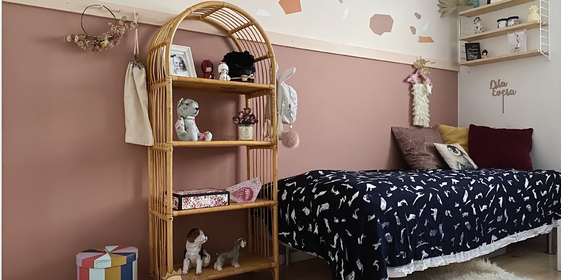 muted pink colour wall in kids room with colourful decorations