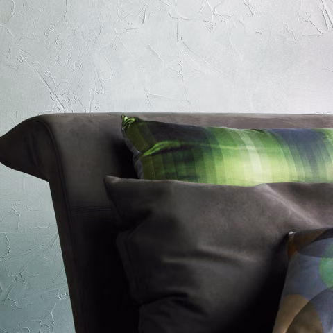 The textured surface, reminiscent of plaster, is finished with a pearlescent sheen. 