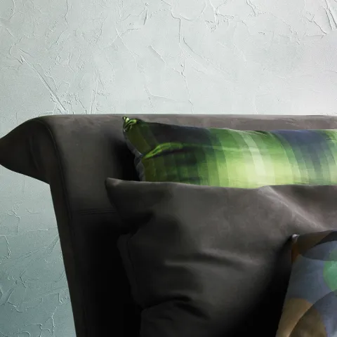 The textured surface, reminiscent of plaster, is finished with a pearlescent sheen. 