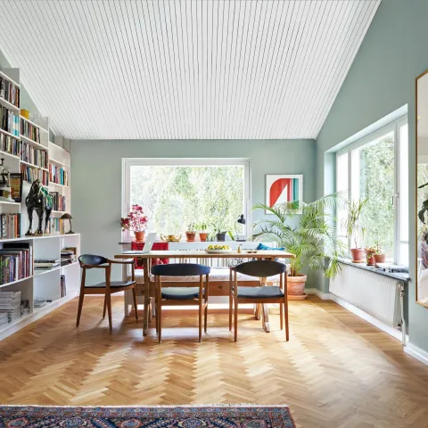 spacious living room with soft green colour wall