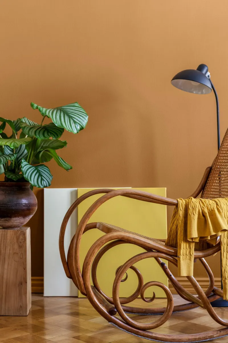 earthy yellow wall colour in living space with rocking chair 