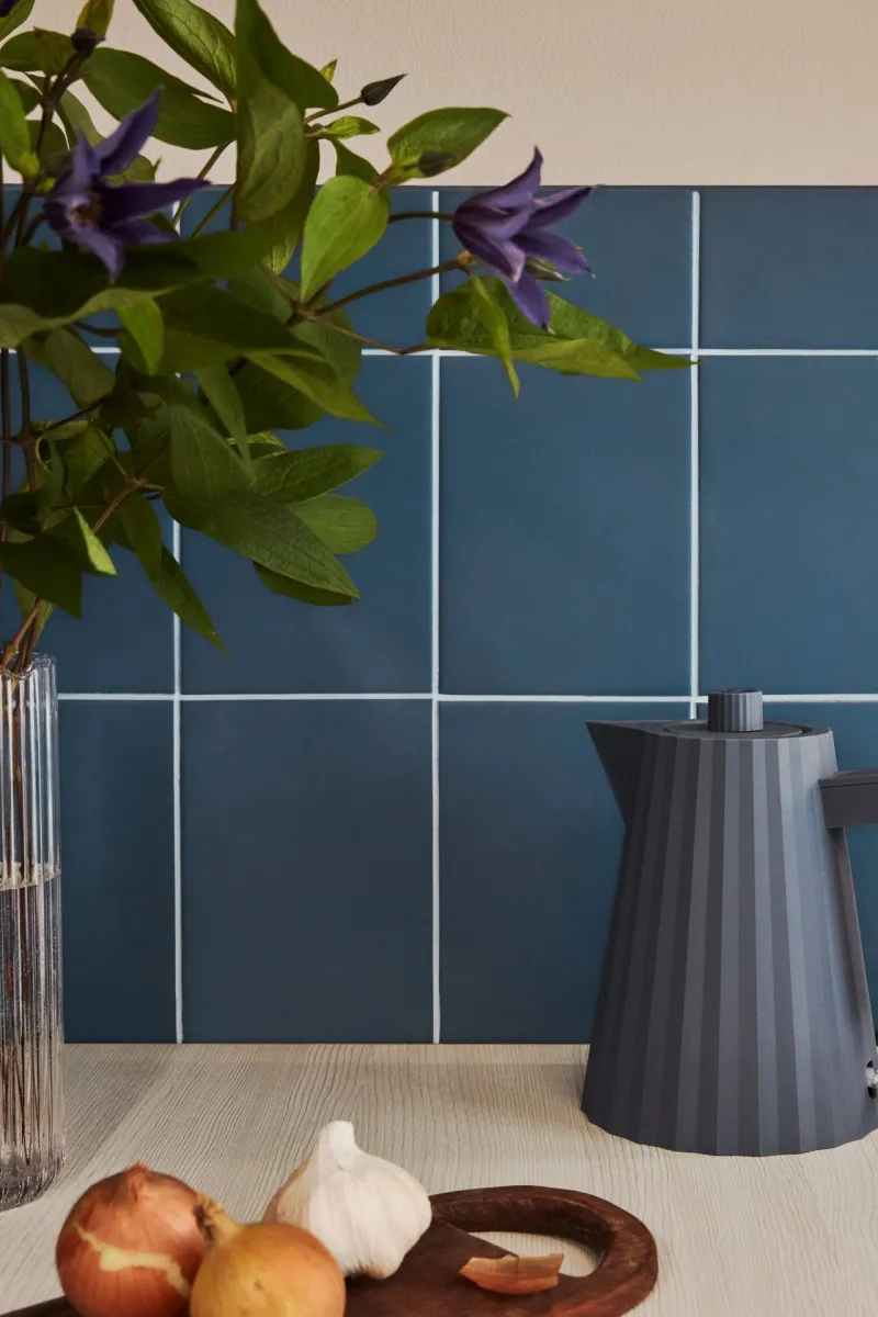 kitchen backsplash tiles painted in blue colour and white joint line